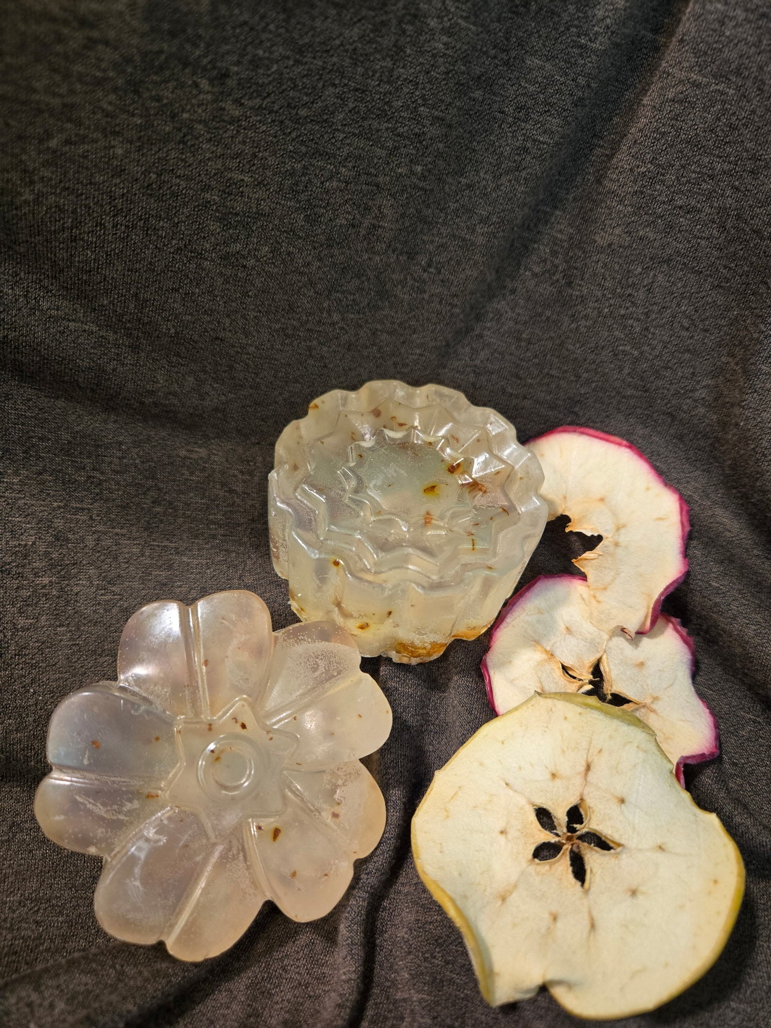 2 formed soaps with sliced dried fruit on the right hand side.